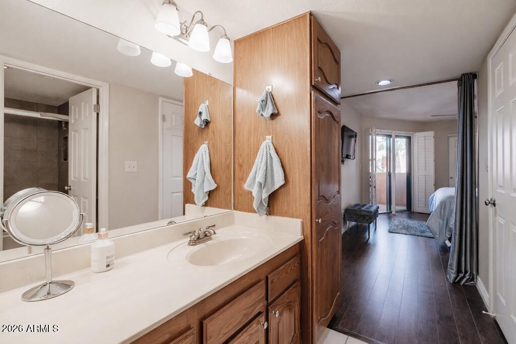 4303 East Cactus Road, Unit 403 Phoenix, AZ 85032 - Photo 18 of 37 a bathroom with a sink double vanity and a mirror