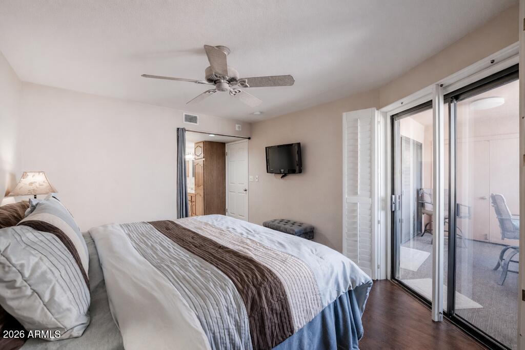 4303 East Cactus Road, Unit 403 Phoenix, AZ 85032 - Photo 19 of 37 a bedroom with a bed and a flat screen tv