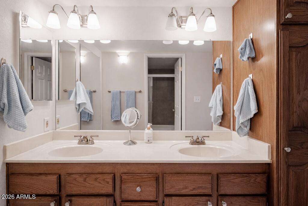 4303 East Cactus Road, Unit 403 Phoenix, AZ 85032 - Photo 20 of 37 a bathroom with a sink double vanity and a mirror