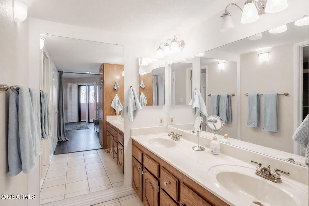 4303 East Cactus Road, Unit 403 Phoenix, AZ 85032 - Photo 21 of 37 a spacious bathroom with a double vanity sink a and a mirror