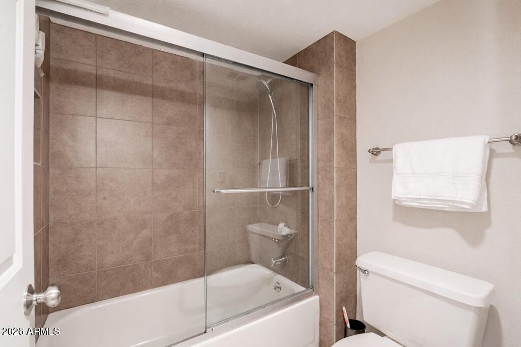4303 East Cactus Road, Unit 403 Phoenix, AZ 85032 - Photo 22 of 37 a bathroom with a shower and a toilet