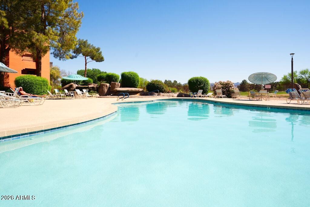 4303 East Cactus Road, Unit 403 Phoenix, AZ 85032 - Photo 29 of 37 a view of a swimming pool and lake view