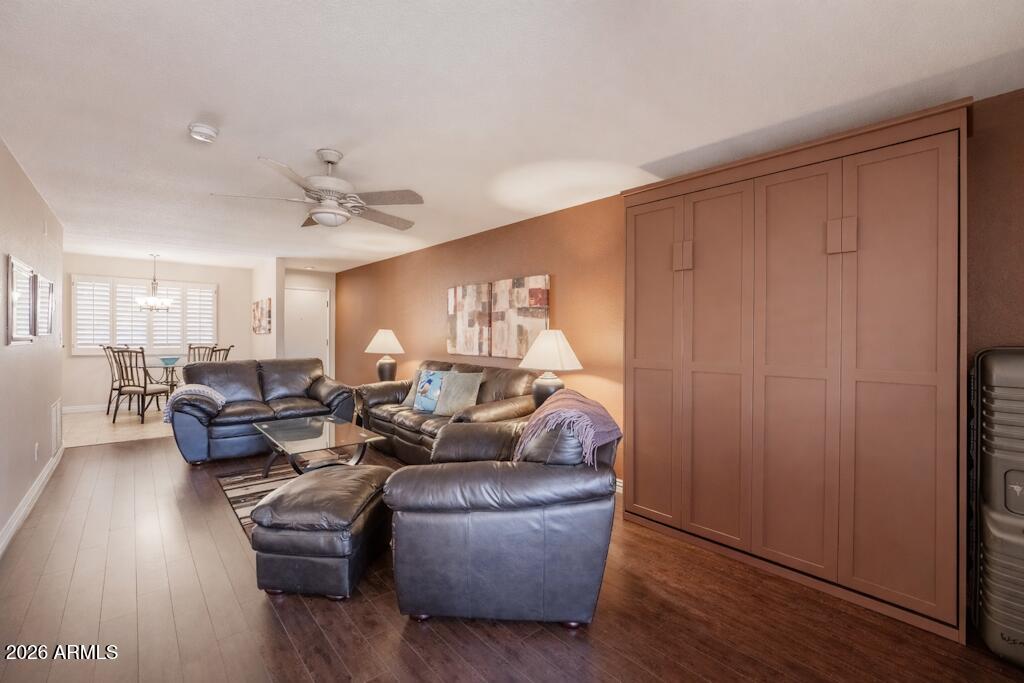 4303 East Cactus Road, Unit 403 Phoenix, AZ 85032 - Photo 3 of 37 a living room with couches and a potted plant on table with wooden floor