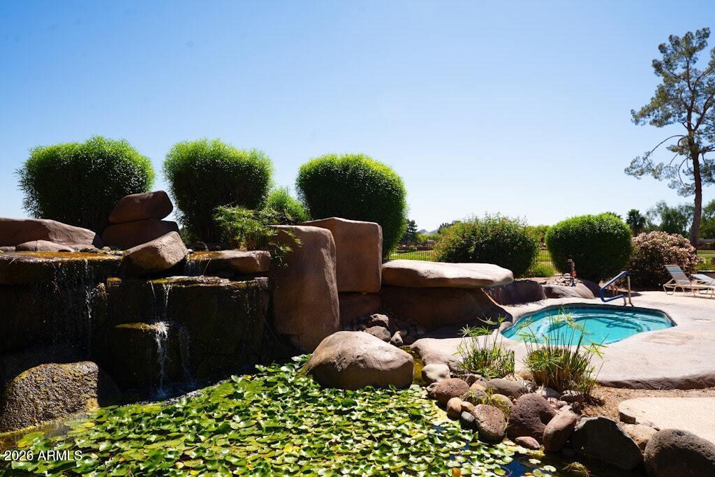 4303 East Cactus Road, Unit 403 Phoenix, AZ 85032 - Photo 36 of 37 a backyard of a house with lots of green space and fog