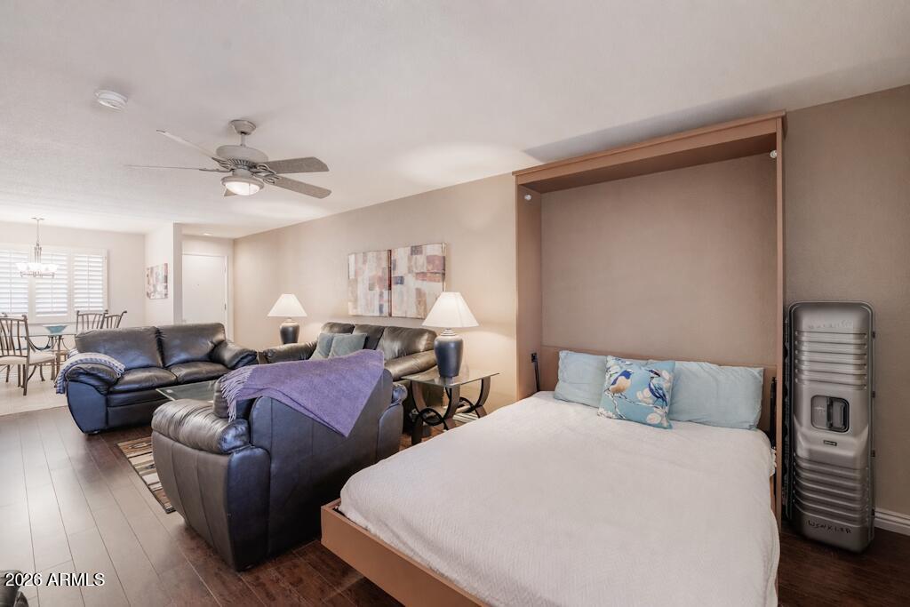 4303 East Cactus Road, Unit 403 Phoenix, AZ 85032 - Photo 5 of 37 a bedroom with two beds and a chandelier