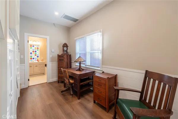 a view of a workspace with furniture and a window