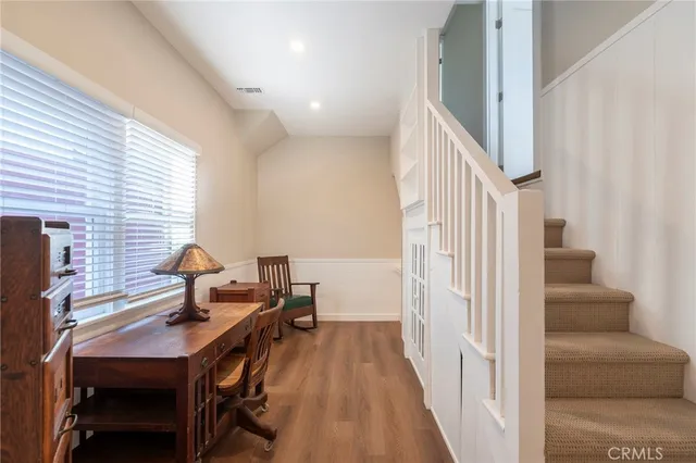 a view of a livingroom with furniture and staircase