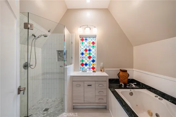 a bathroom with a sink mirror and shower