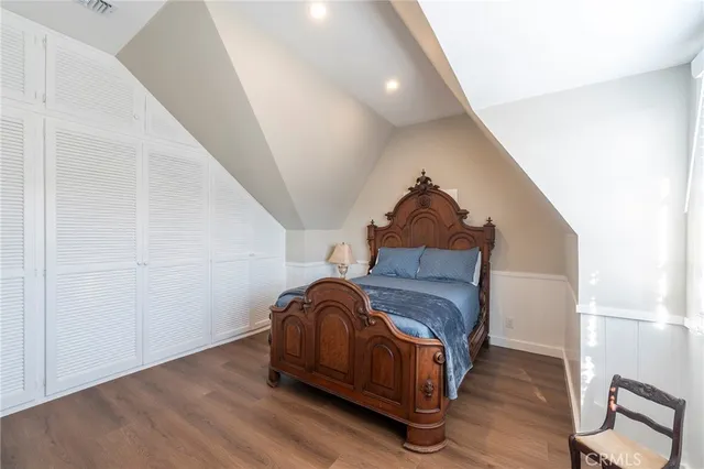 a room with a bed and wooden floor