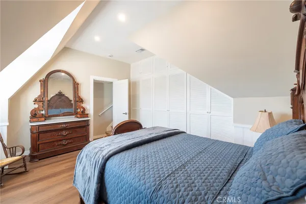 a bedroom with a bed and a dresser