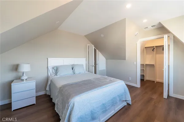 a bedroom with a bed and a lamp