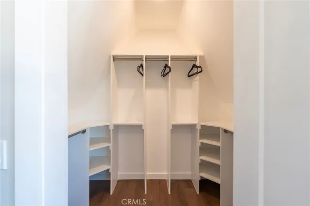 a view of walk in closet with empty racks