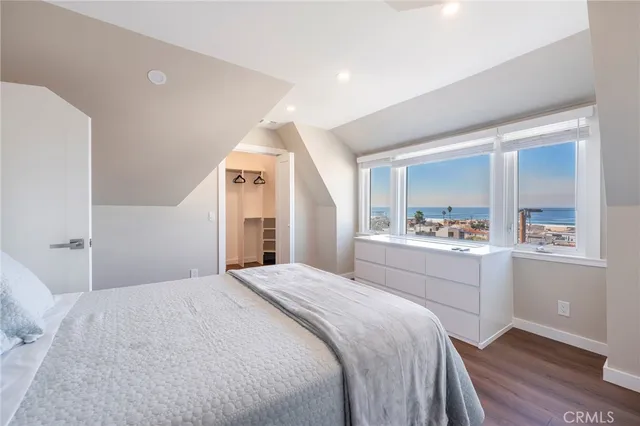 a bedroom with a bed and a view of kitchen