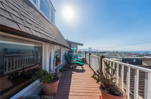 a view of a balcony with outdoor seating