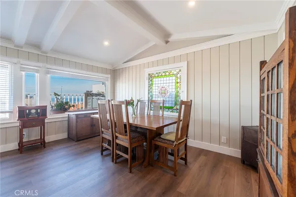 a dining room with furniture and wooden floor