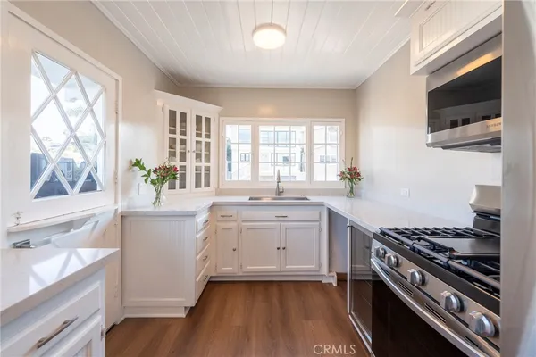 a kitchen with sink a microwave and stove