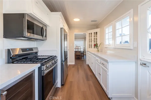 a kitchen with stainless steel appliances granite countertop a stove and a microwave