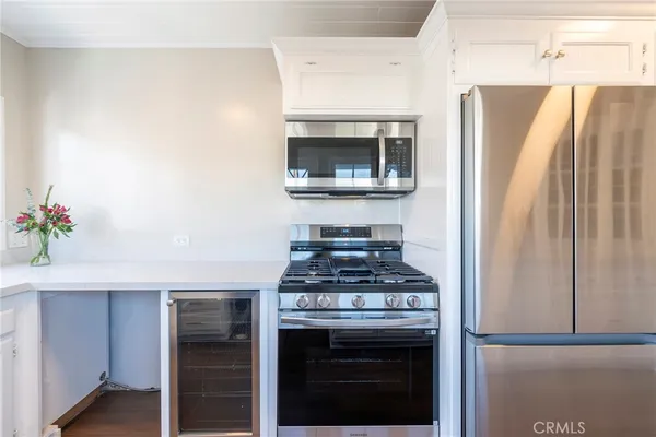 a kitchen with stainless steel appliances granite countertop a refrigerator and a stove