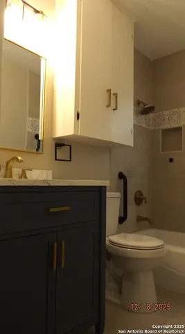 a bathroom with a bathtub and a window