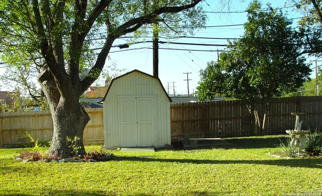 a view of a house with a yard in front of it