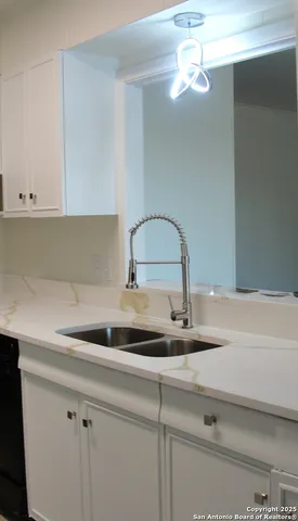 a stove top oven sitting inside of a kitchen