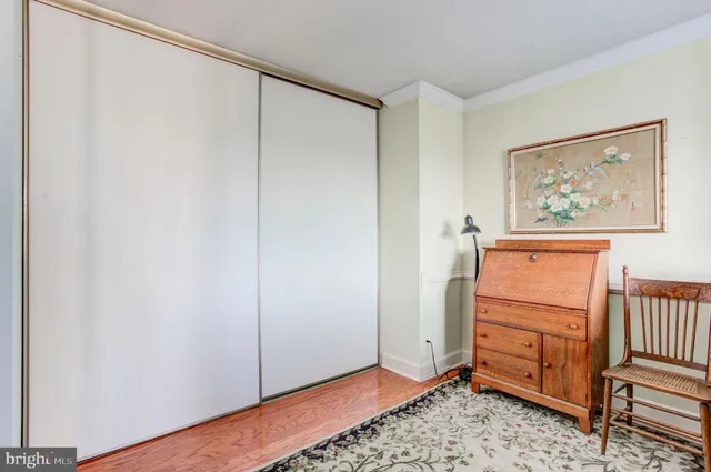 a view of a room with wooden floor and cabinet