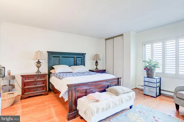 a bedroom with two beds and painting on the wall