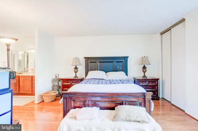 a bedroom with a bed and wooden floor