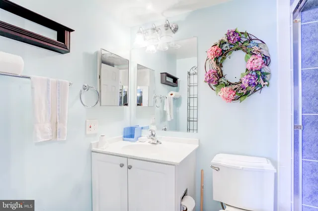 a bathroom with a sink mirror and vanity