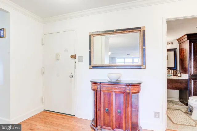 a view of a small space with wooden floor and a window