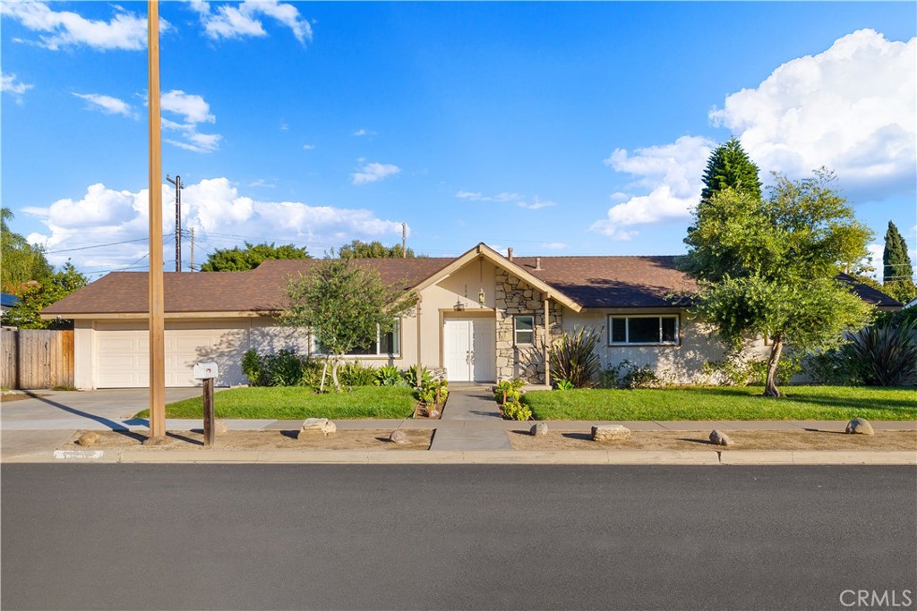 13402 Winthrope Street North Tustin, CA 92705 - Photo 1 of 34 a front view of a house with a yard and potted plants