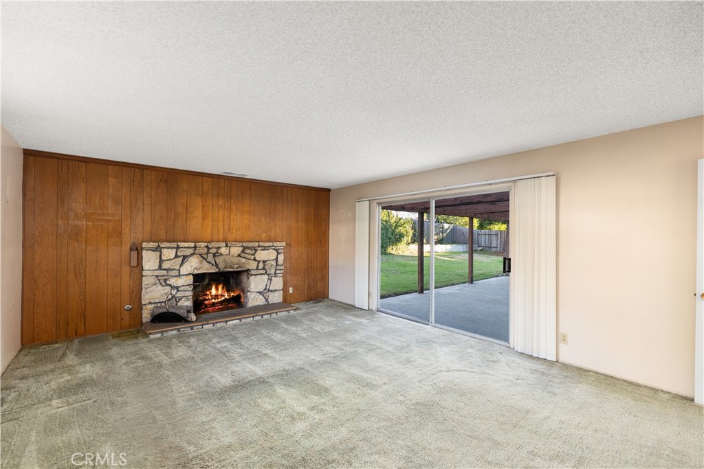 13402 Winthrope Street North Tustin, CA 92705 - Photo 11 of 34 a view of an empty room with a fireplace and a window