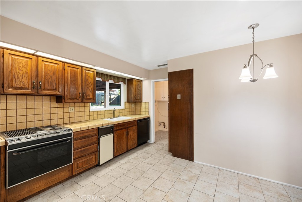 13402 Winthrope Street North Tustin, CA 92705 - Photo 17 of 34 a kitchen with stainless steel appliances granite countertop a stove and a sink