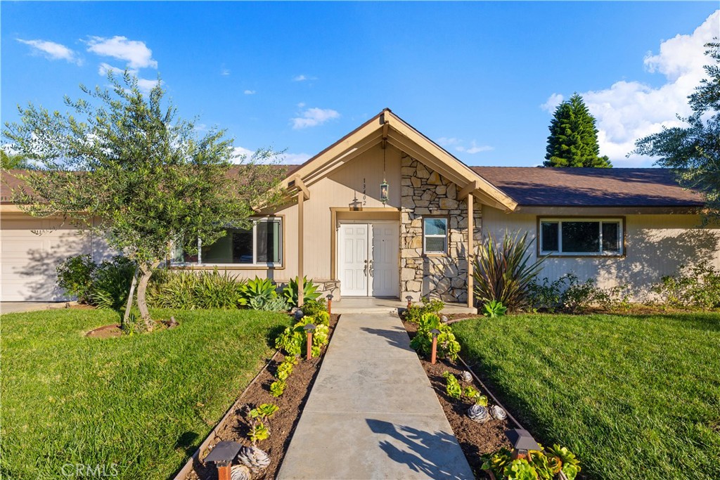 13402 Winthrope Street North Tustin, CA 92705 - Photo 3 of 34 a front view of house with yard and green space