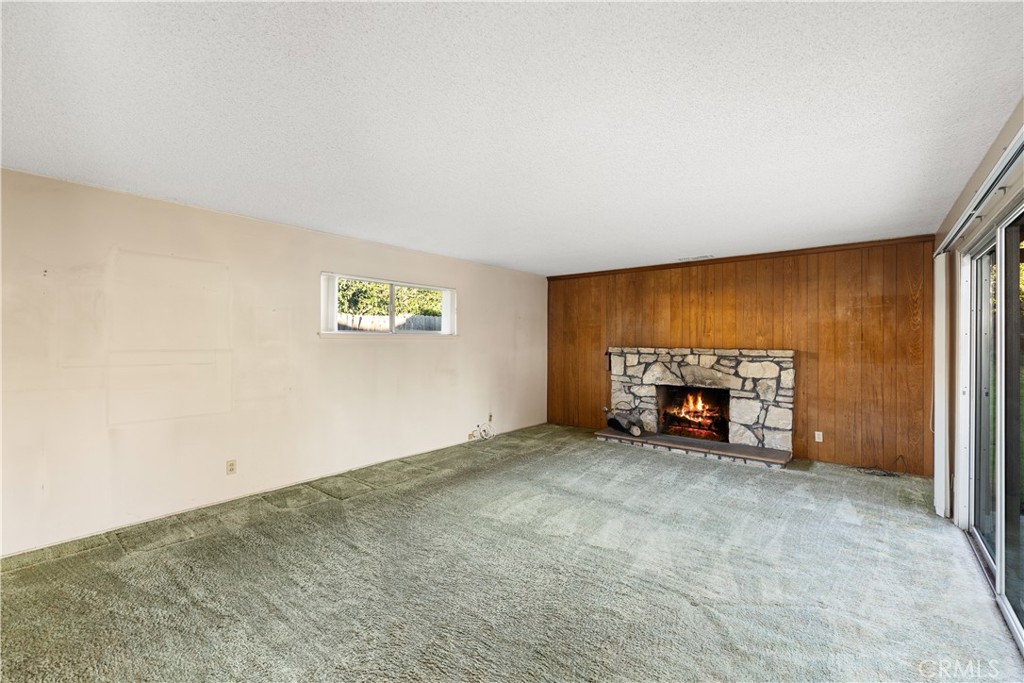 13402 Winthrope Street North Tustin, CA 92705 - Photo 10 of 34 an empty room with a fireplace and a window