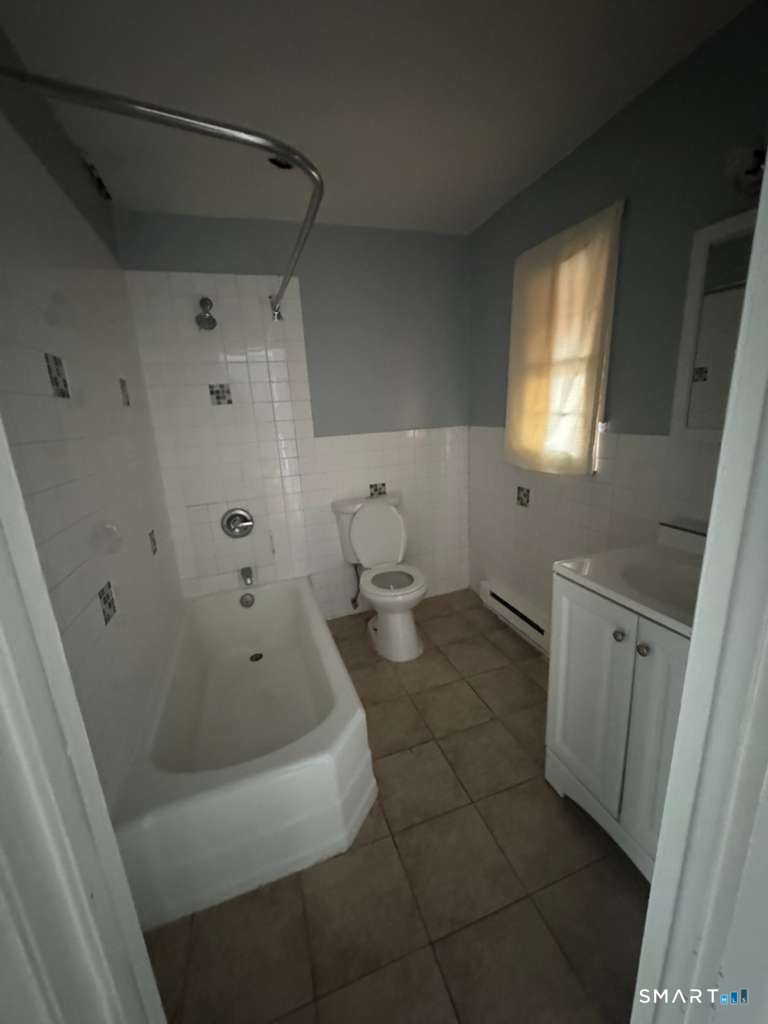 240 Oak Street, Unit 27 Bridgeport, CT 06604 - Photo 4 of 5 a bathroom with a bathtub and a shower