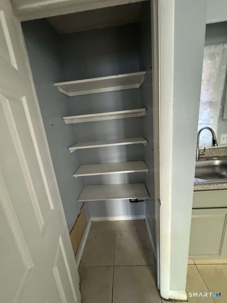 240 Oak Street, Unit 27 Bridgeport, CT 06604 - Photo 5 of 5 a view of walk in closet with empty racks