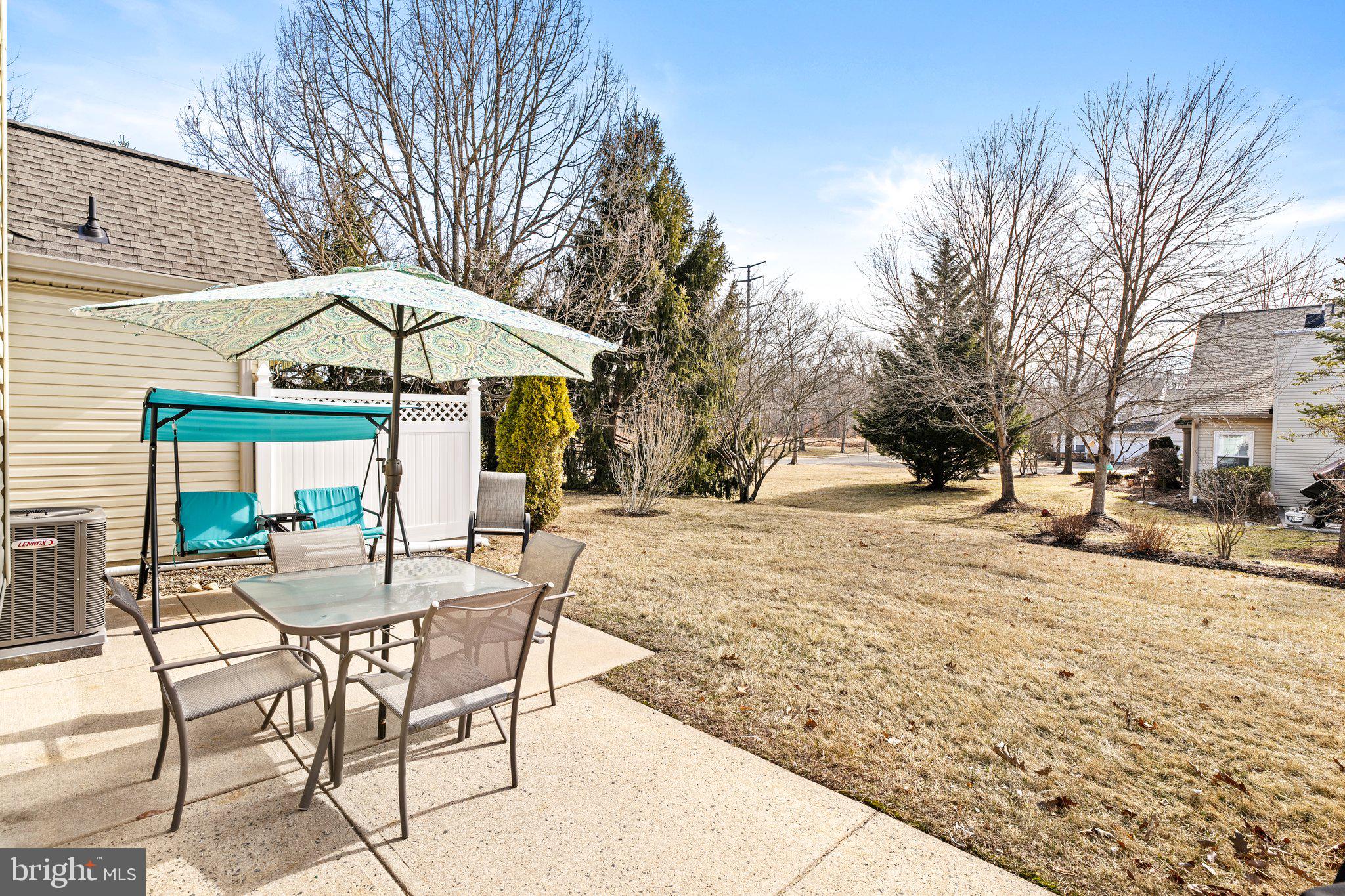 26 Brecht Road Hamilton, NJ 08690 - Photo 24 of 25 a view of a backyard with table and chairs under an umbrella