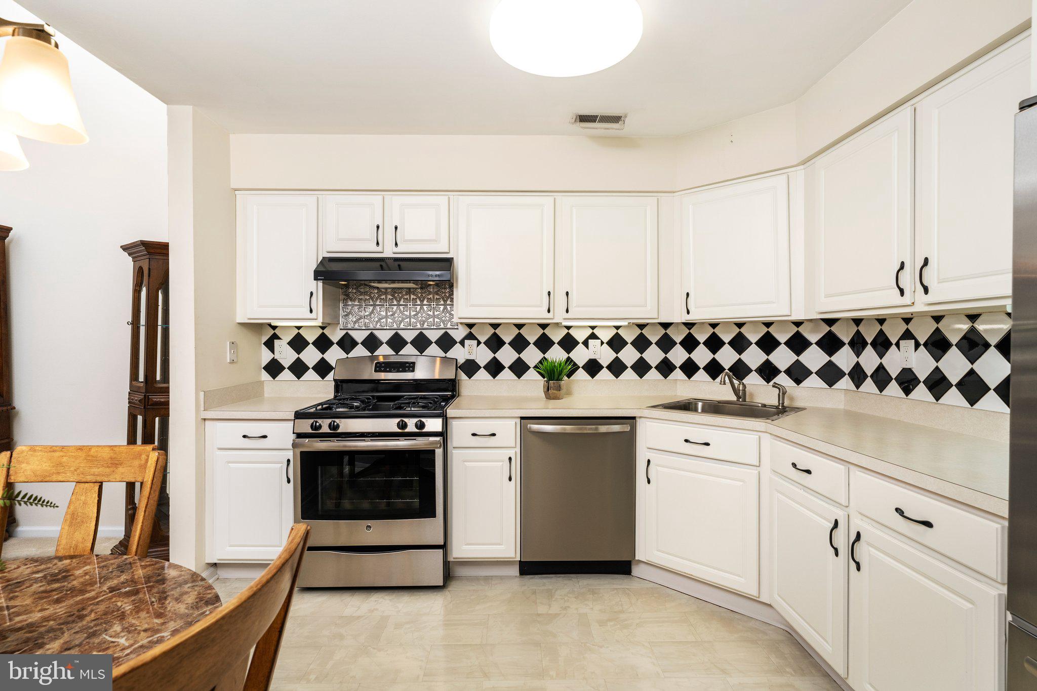 26 Brecht Road Hamilton, NJ 08690 - Photo 7 of 25 a kitchen with white cabinets and appliances