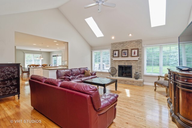 20 Lochbrook Lane Inverness, IL 60010 - Photo 3 of 27 a living room with furniture a large window and a fireplace