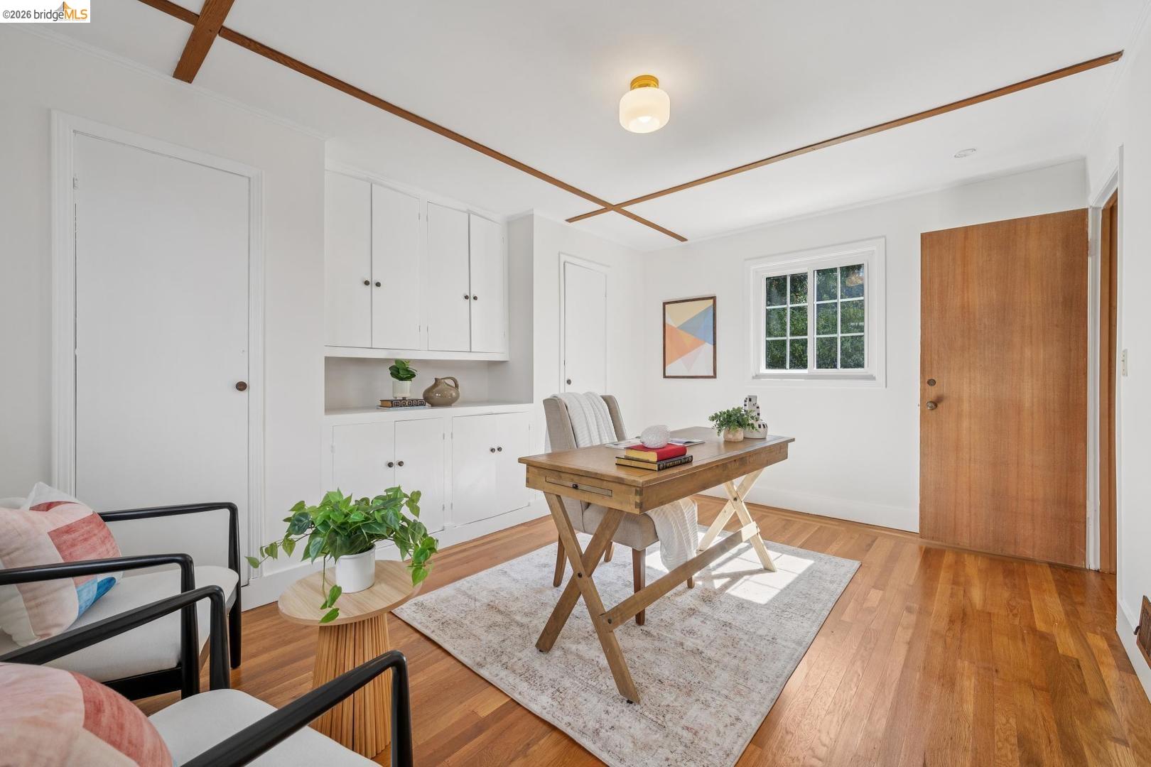 155 Avenida Drive Berkeley, CA 94708 - Photo 31 of 86 Hardwood flooring, white built-in cabinetry, window with multiple panes, wooden ceiling accents, and a flush-mount ceiling light
