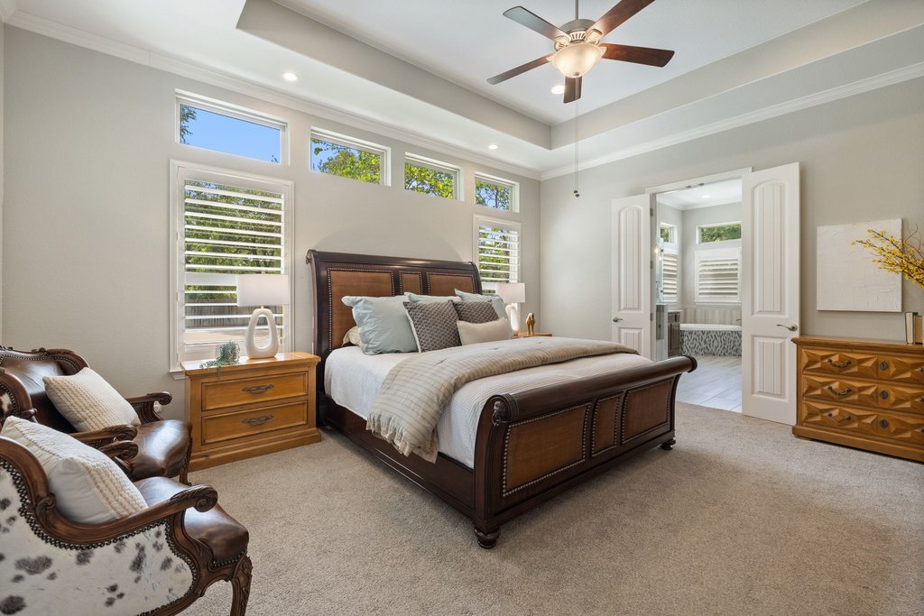 108 Berry Cove Georgetown, TX 78628 - Photo 17 of 39 a bed room with a bed and a chandelier