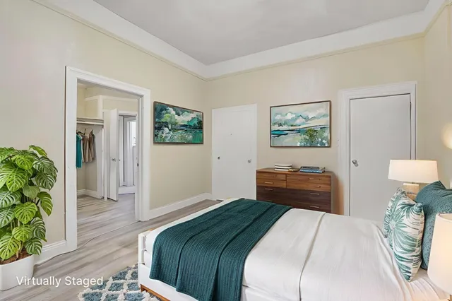 a bedroom with bed and dresser