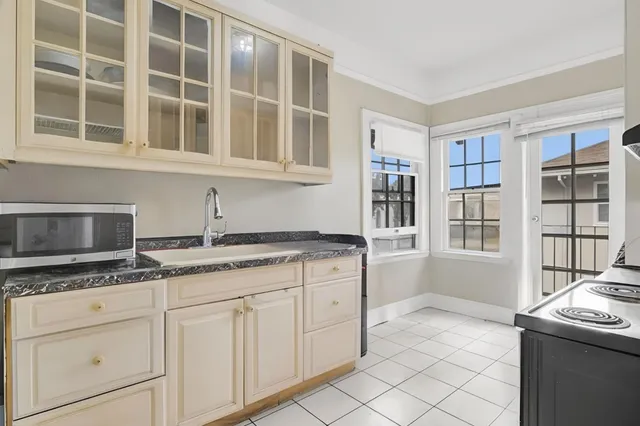 a kitchen with granite countertop a sink and cabinets