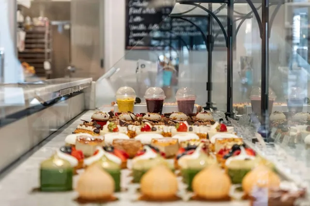 a front view of a building with an umbrella and a tree