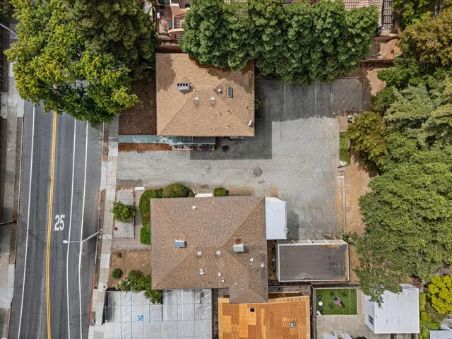 an aerial view of residential house with outdoor space and trees