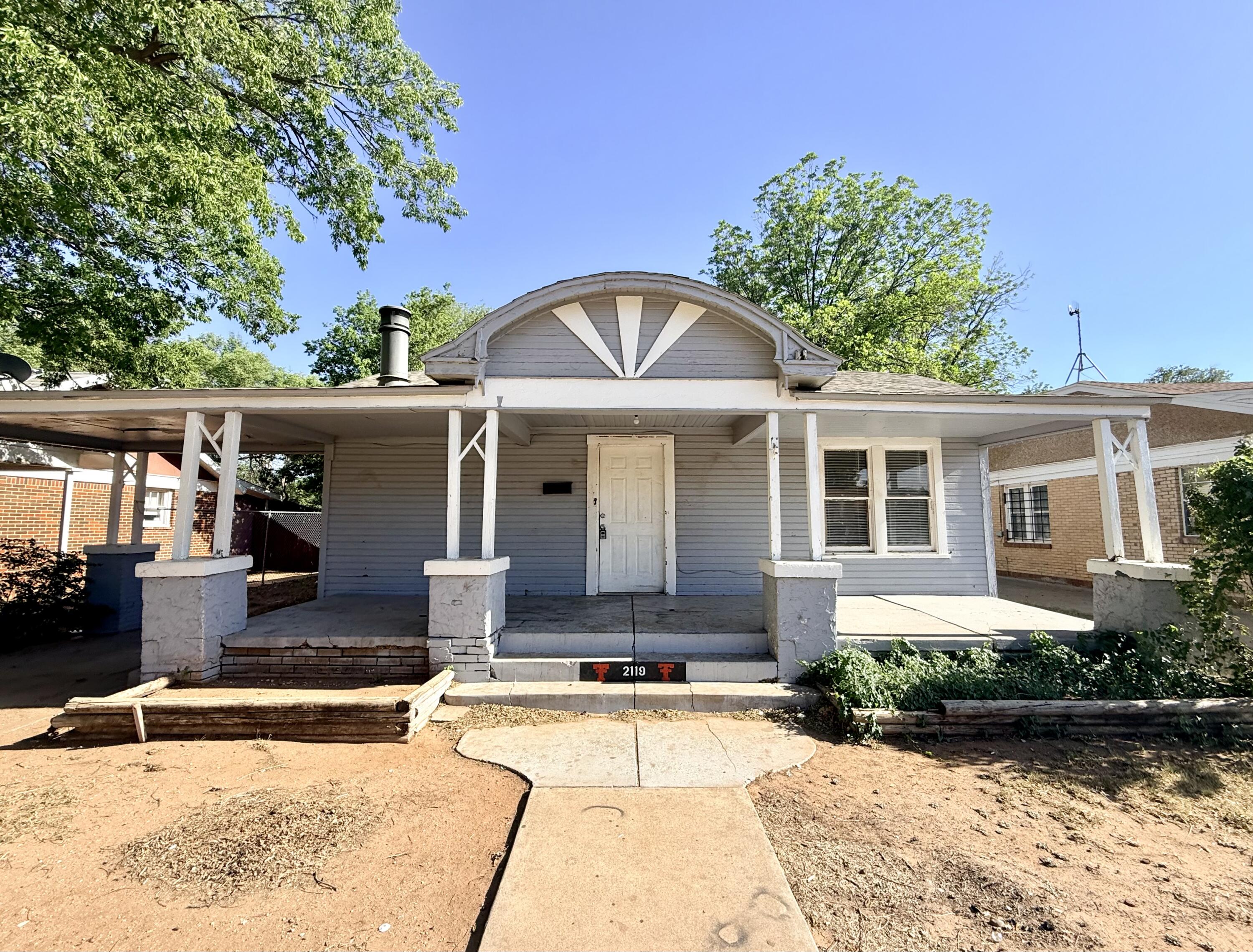2119 15th Street Lubbock, TX 79401 - Photo 1 of 15 a front view of a house with garden