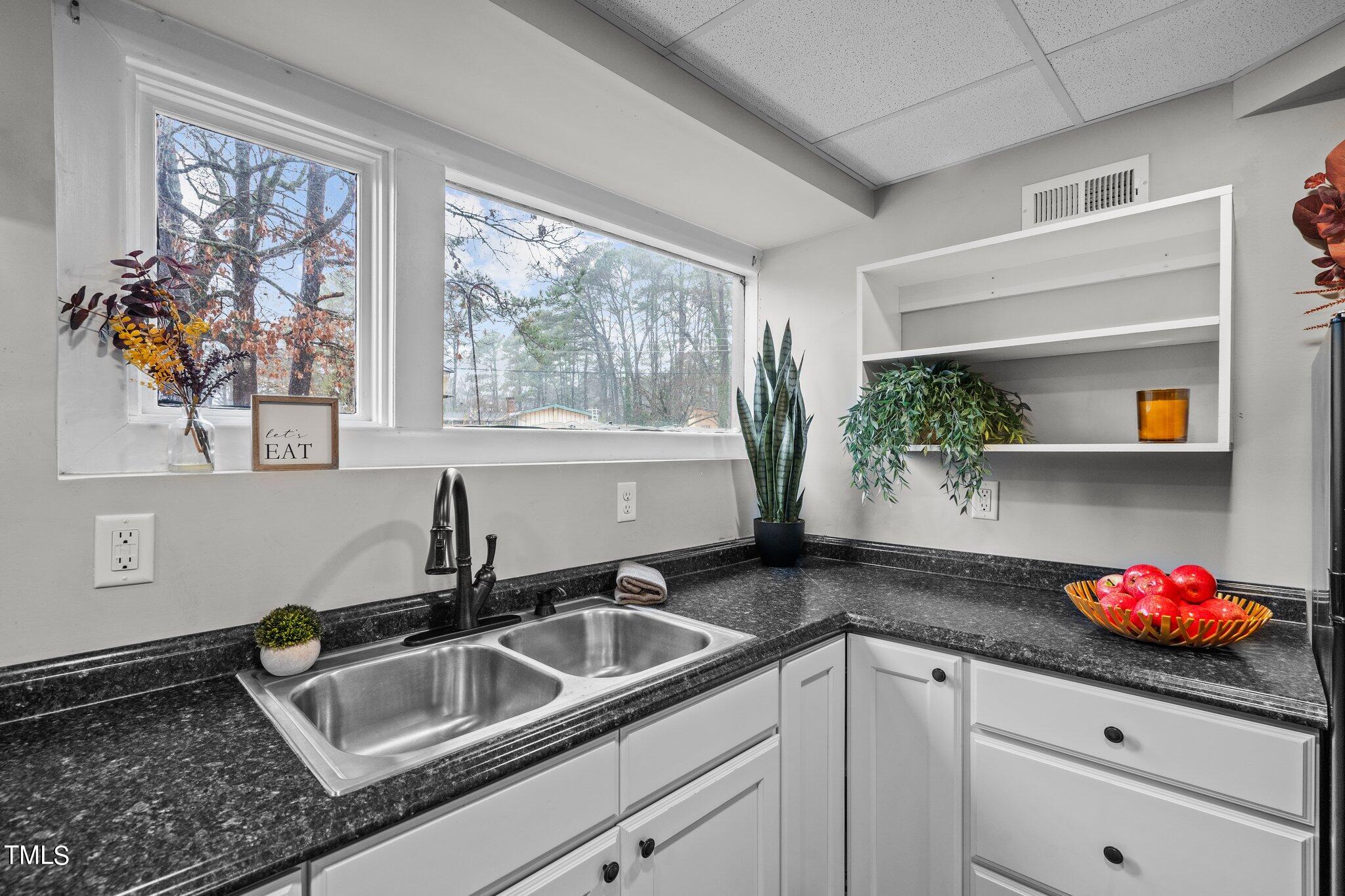 3500 Baugh Street Raleigh, NC 27604 - Photo 24 of 34 a kitchen with granite countertop a sink stove and window