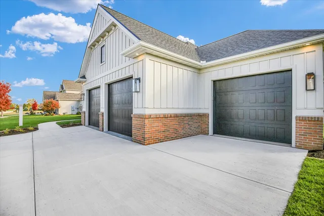 a view of a hallway with wooden floor and a living room