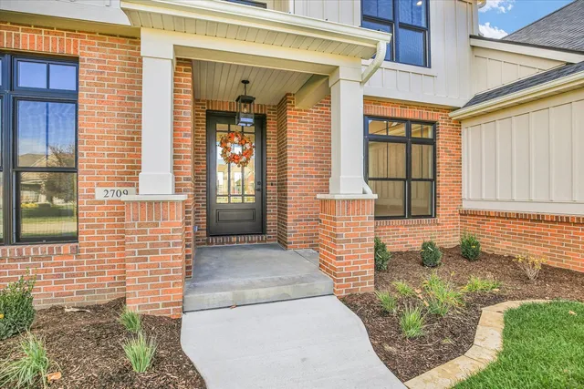 a kitchen with stainless steel appliances a white cabinets and wooden floor